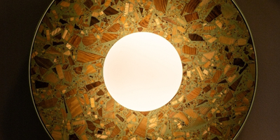 round wall lamp in sage colour made of wood chips